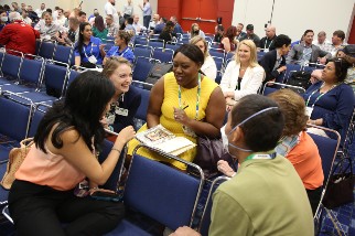Members sitting in a classroom and laughing at Safety 2022