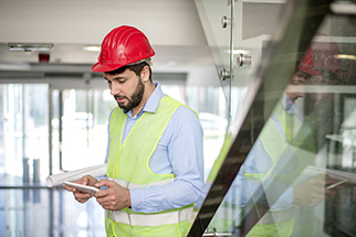 Safety-professional-reviewing-data-on-tablet